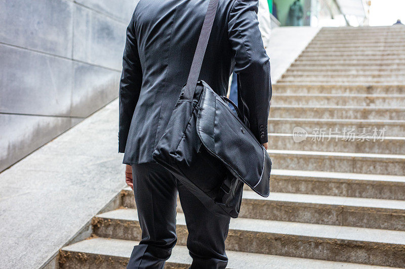 Businessman walking up stairs